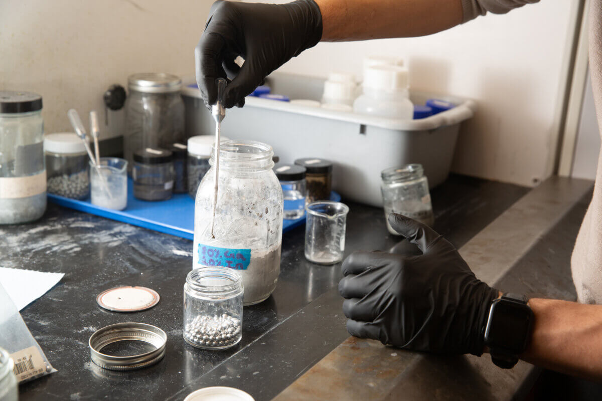 A researcher demonstrates “activating” aluminum by dipping an aluminum pellet in a mixture of gallium-indium. 