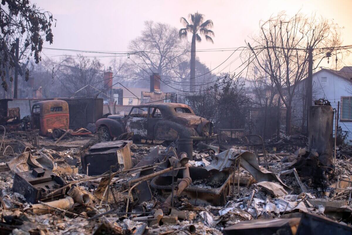 Charred vehicles lie in devastation as wildfires rage in the Los Angeles area