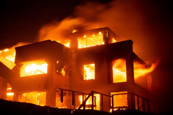 Flames engulf a structure as the Palisades Fire rages