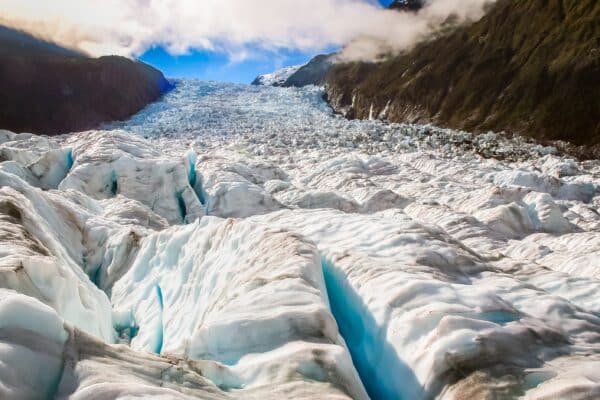 A glacier carving a valley in rock