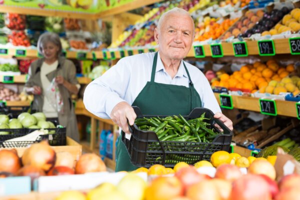 Elderly man working at a grocery store