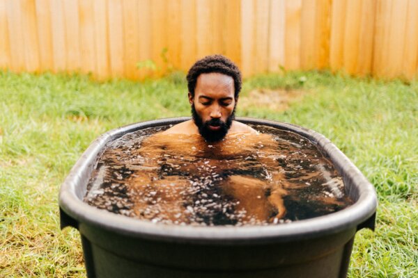 Man concentrates while sitting in an ice bath