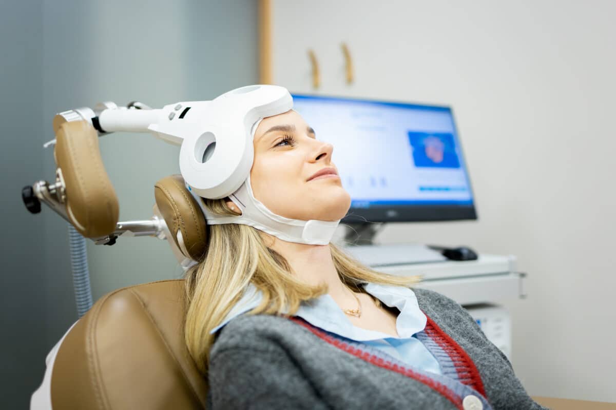 A patient undergoes transcranial magnetic stimulation