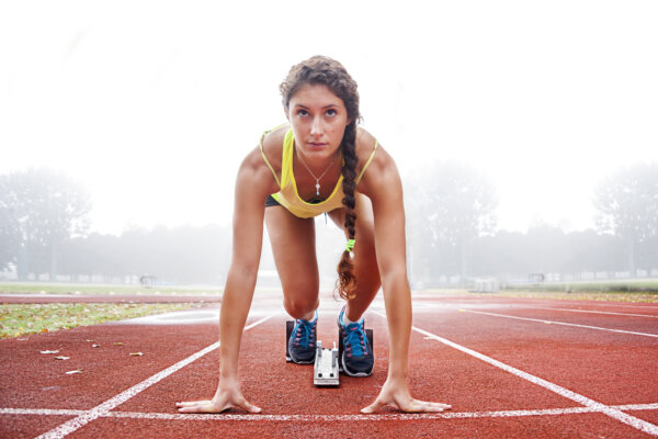 Track runner on the starting blocks