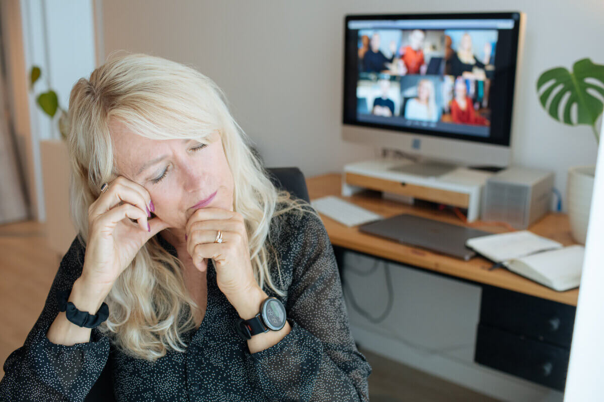 A woman is tired during a Zoom call