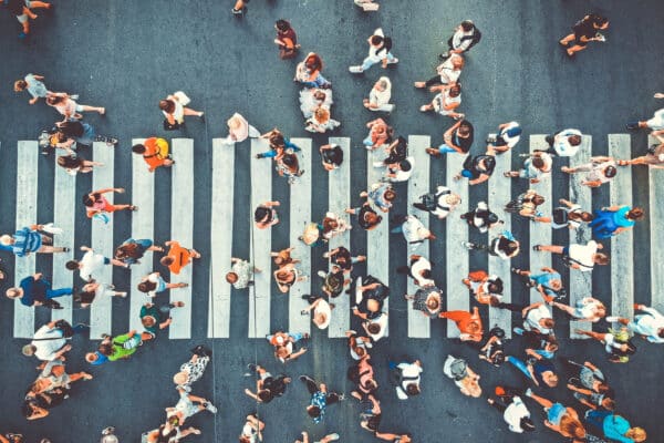 Aerial view of crowd walking on pedestrian crosswalk