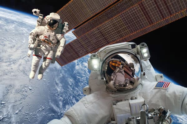 Astronauts floating outside the International Space Station