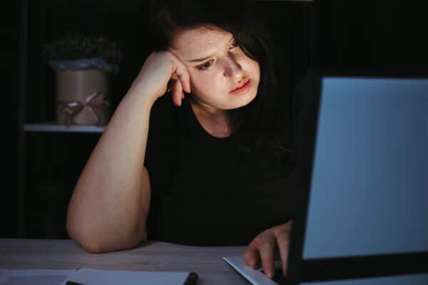 Woman working on computer at night