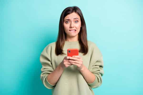 Woman anxious about smartphone or social media or text message