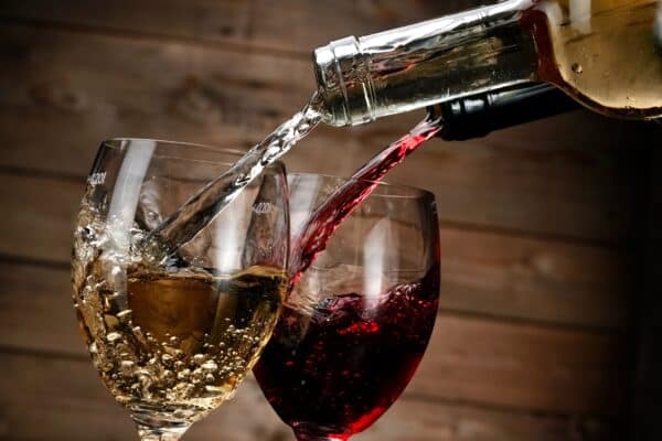 Red and white wine poured into glasses