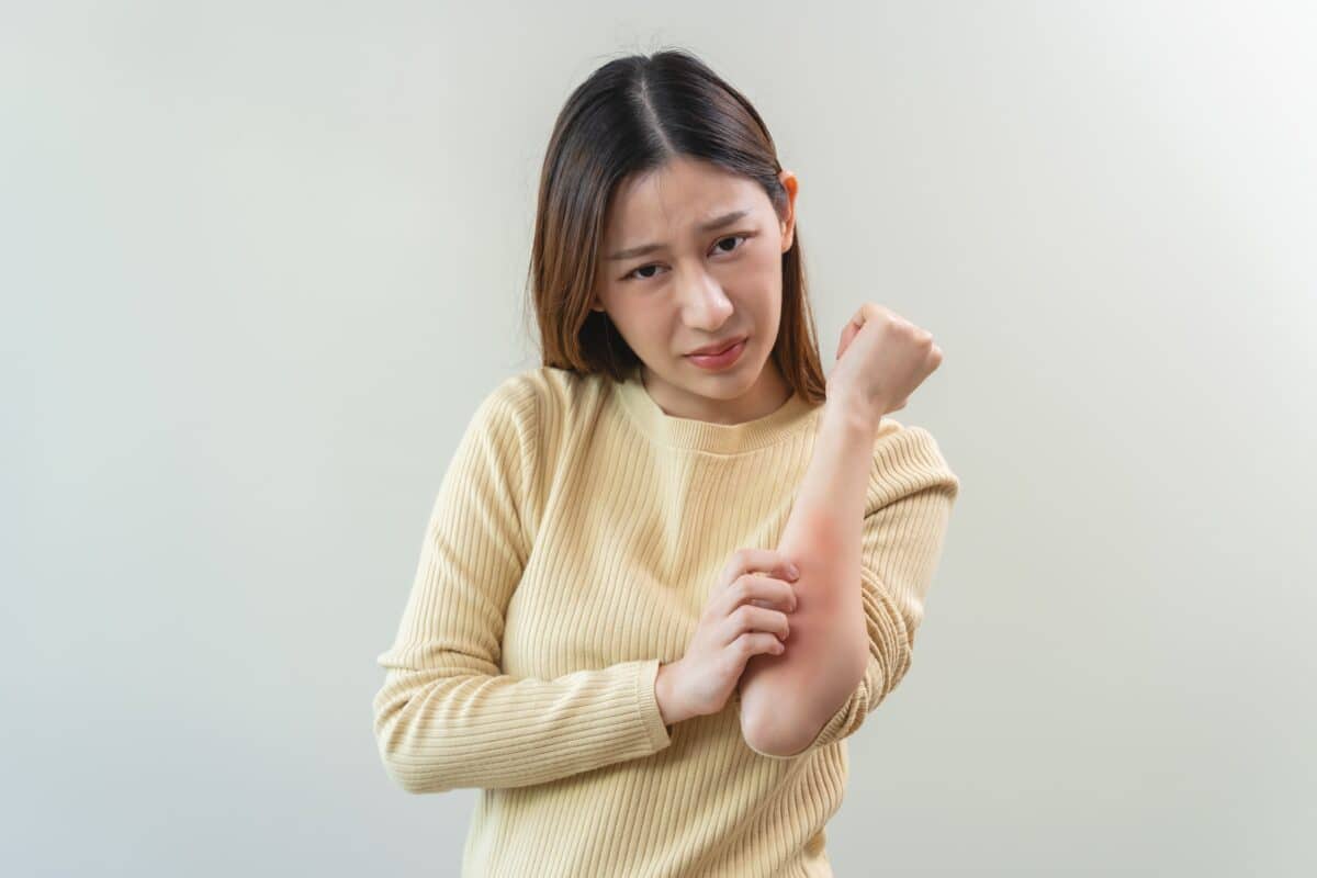 A woman scratching an itch