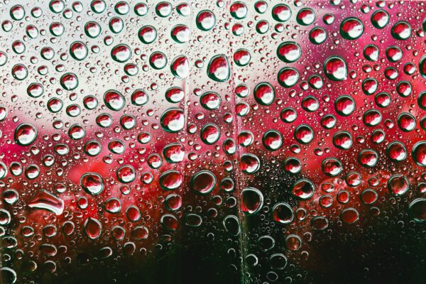 Glass window or windshield with rain drops