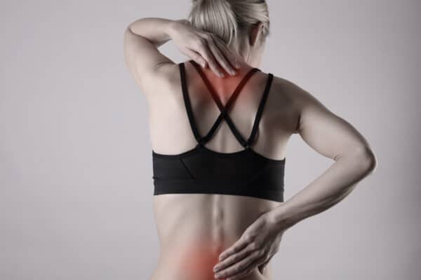 A woman with back pain from exercise