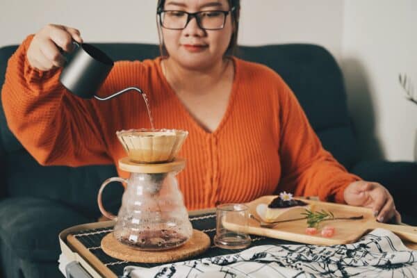Woman makes a cup of pour-over-coffee