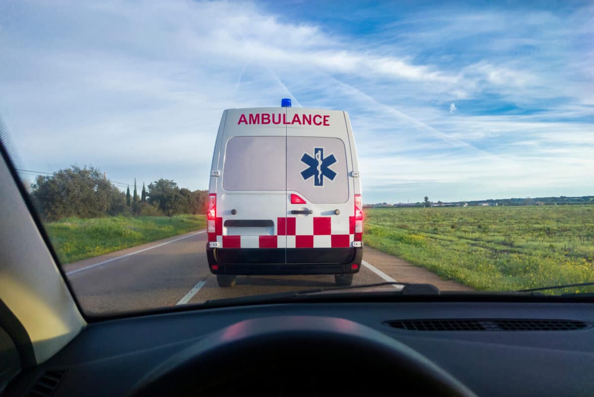 Driving behind an amulance on a rural road