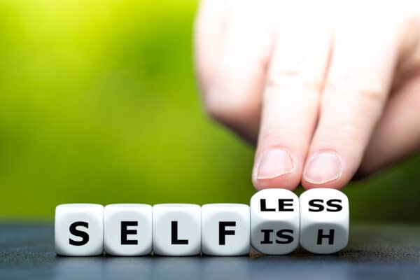 Switching between selfish and selfless