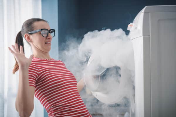 A woman with a smoking washing machine