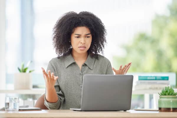 Stressed woman annoyed with work computer