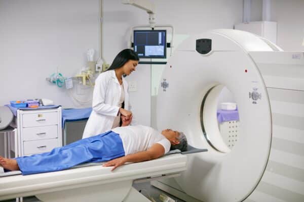 Radiologist with patient undergoing a CT scan