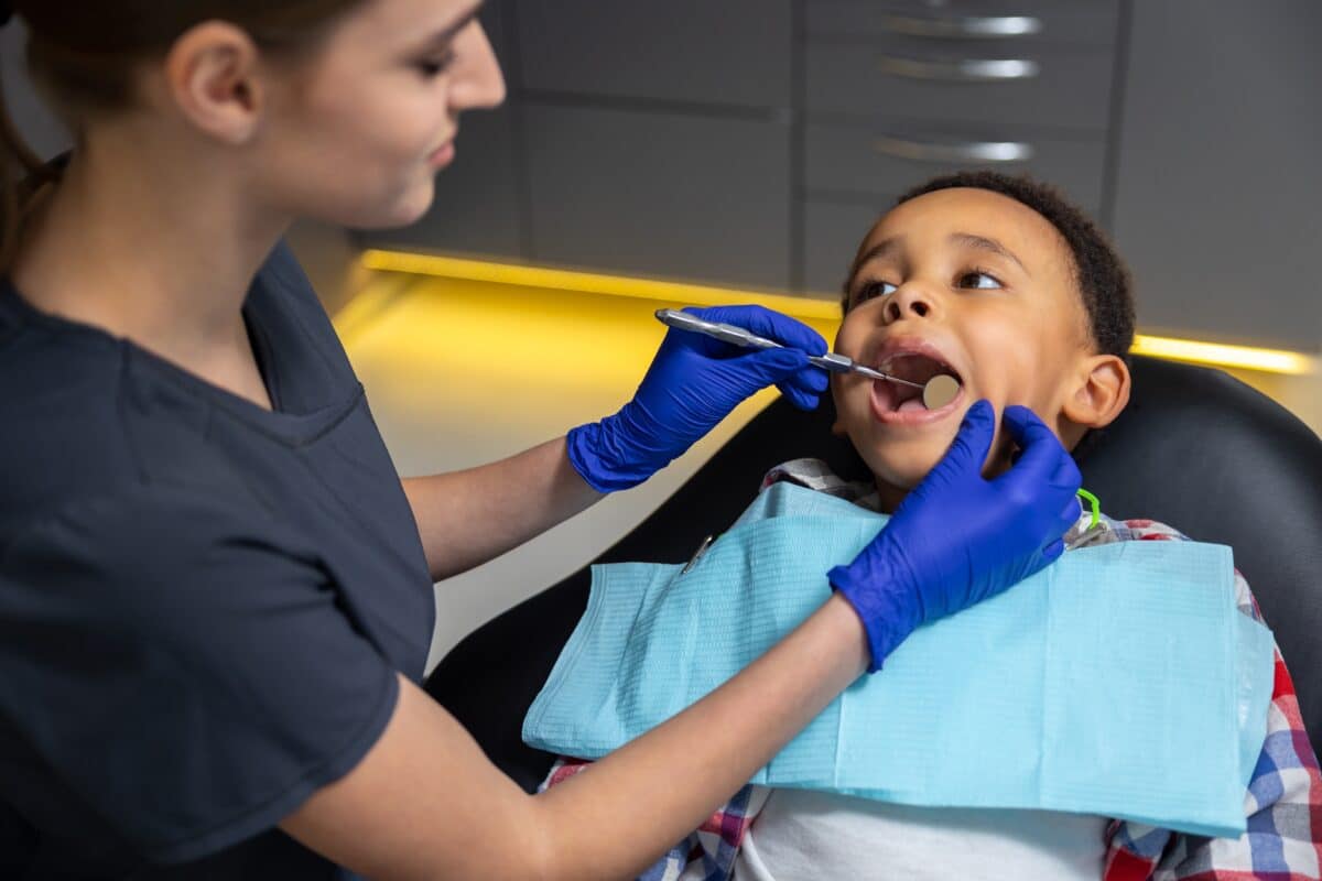 Dentist looking in child’s mouth