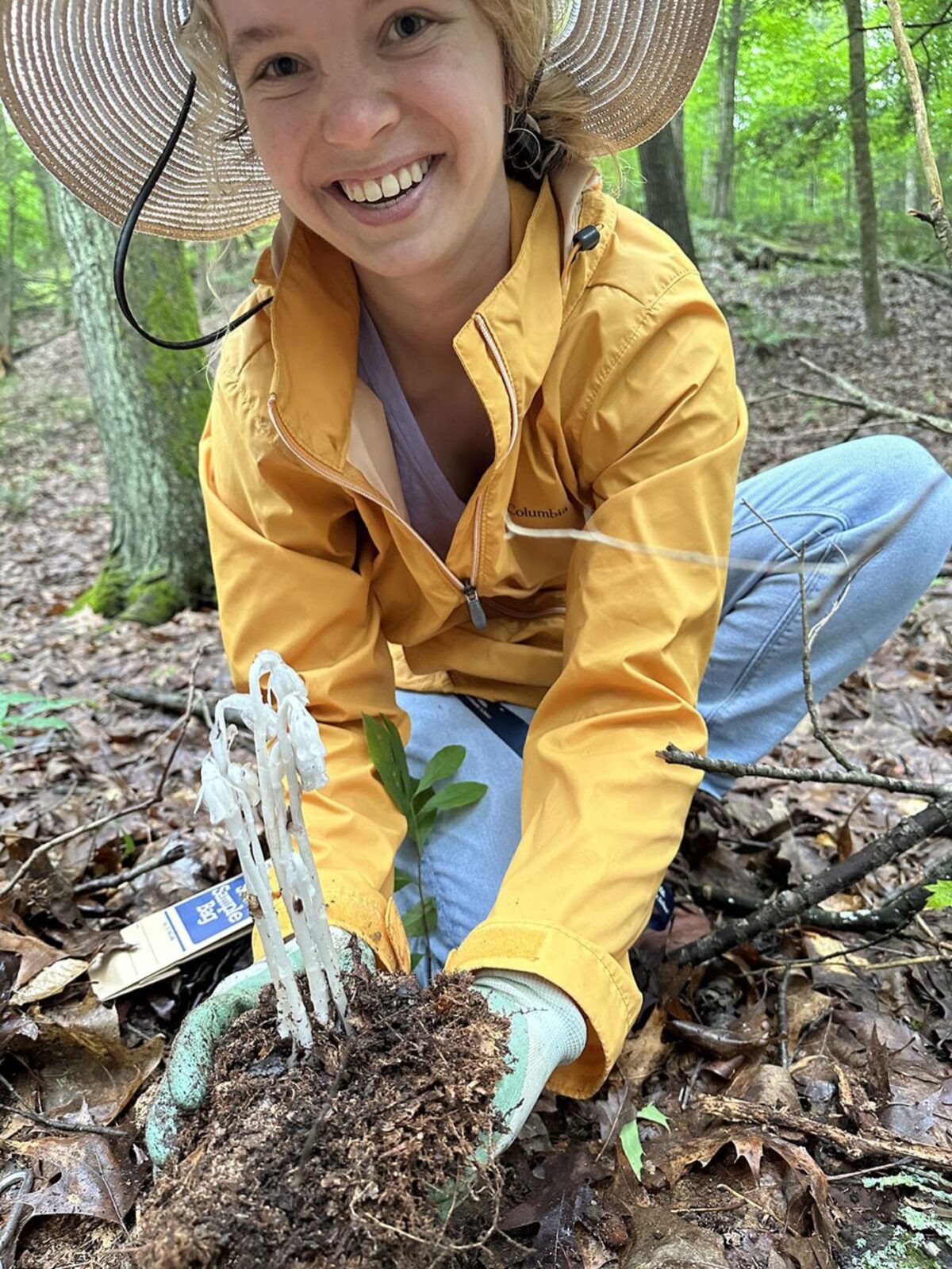Study first author Savannah Anez shows a clump of ghost pipe.