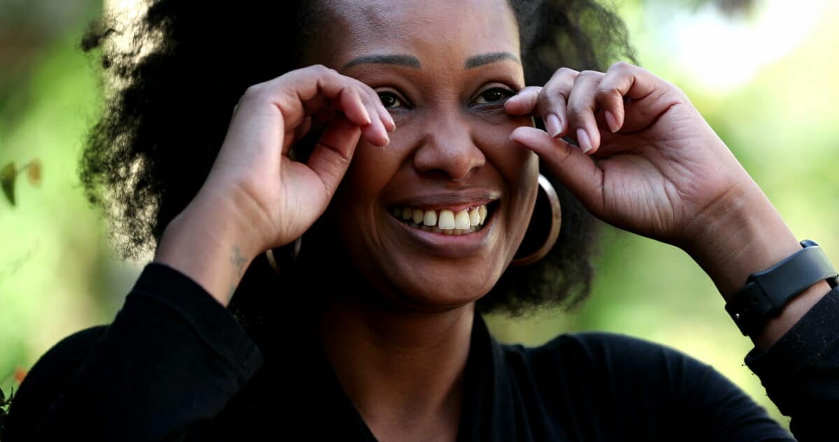 Woman wiping happy tears with fingers