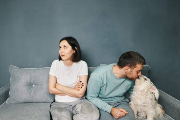 Woman jealous as boyfriend or husband kisses the dog