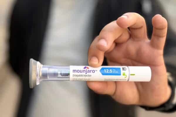 Person holding a vial of Mounjaro (tirzepatide)