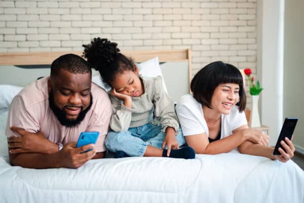 Parents on their phones are ignoring their bored child