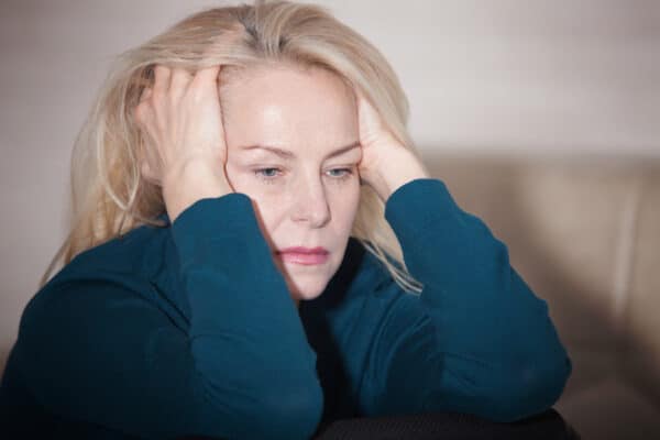 Middle-aged woman stressed, upset, angry, or sad, perhaps from menopause