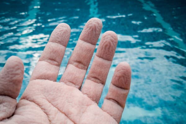 Pruney fingers by a pool