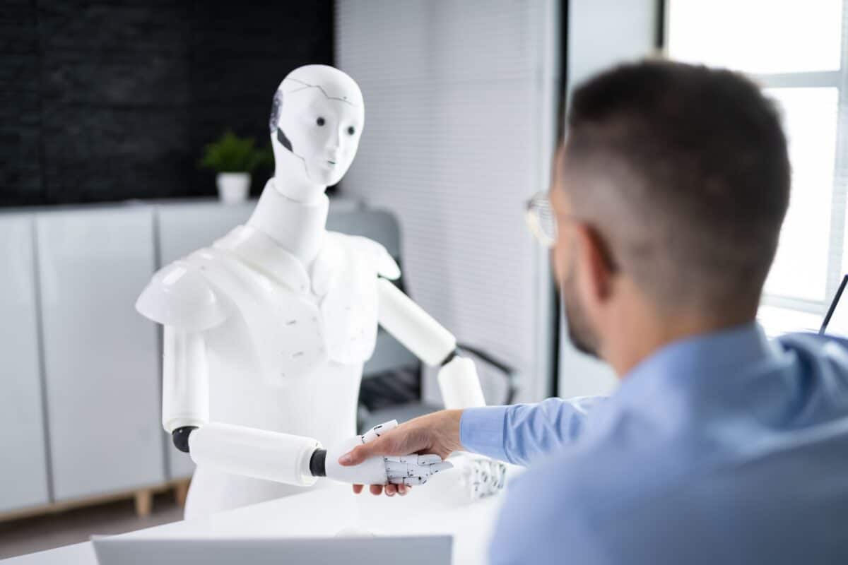 An AI robot hiring manager shaking hands with a candidate