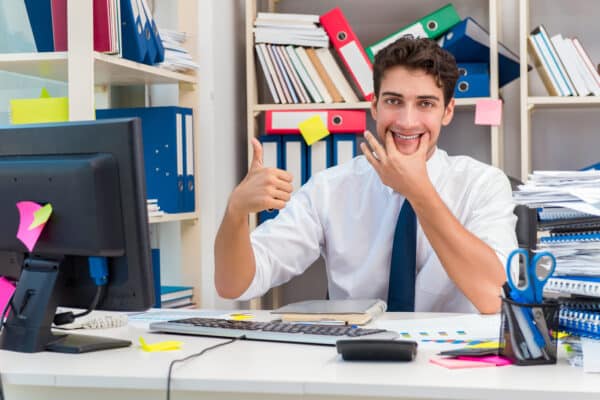 A man putting on a fake smile at work