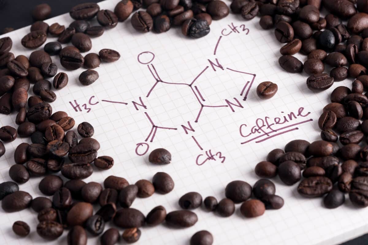 Coffee beans with caffeine molecule formula written