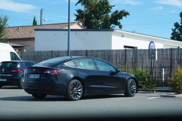 Tesla reversing in parking lot