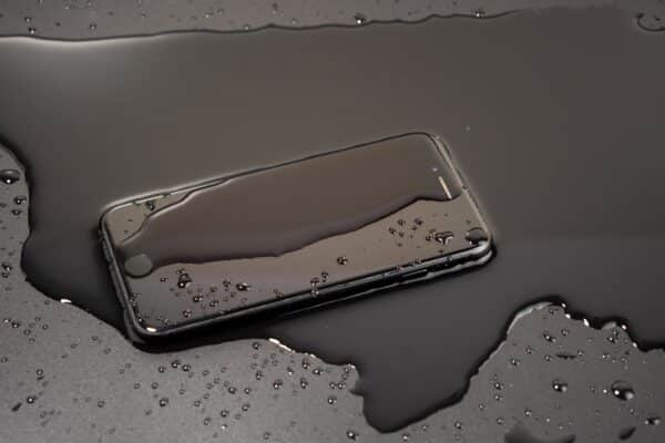Smartphone sitting in a puddle of water