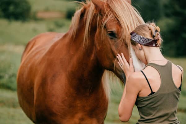 A girl hugging her horse