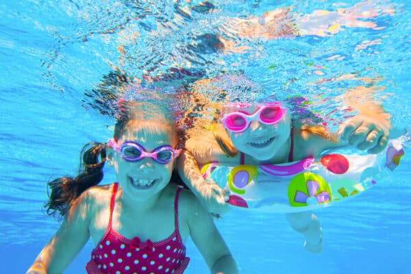 Girls underwater in swimming pool