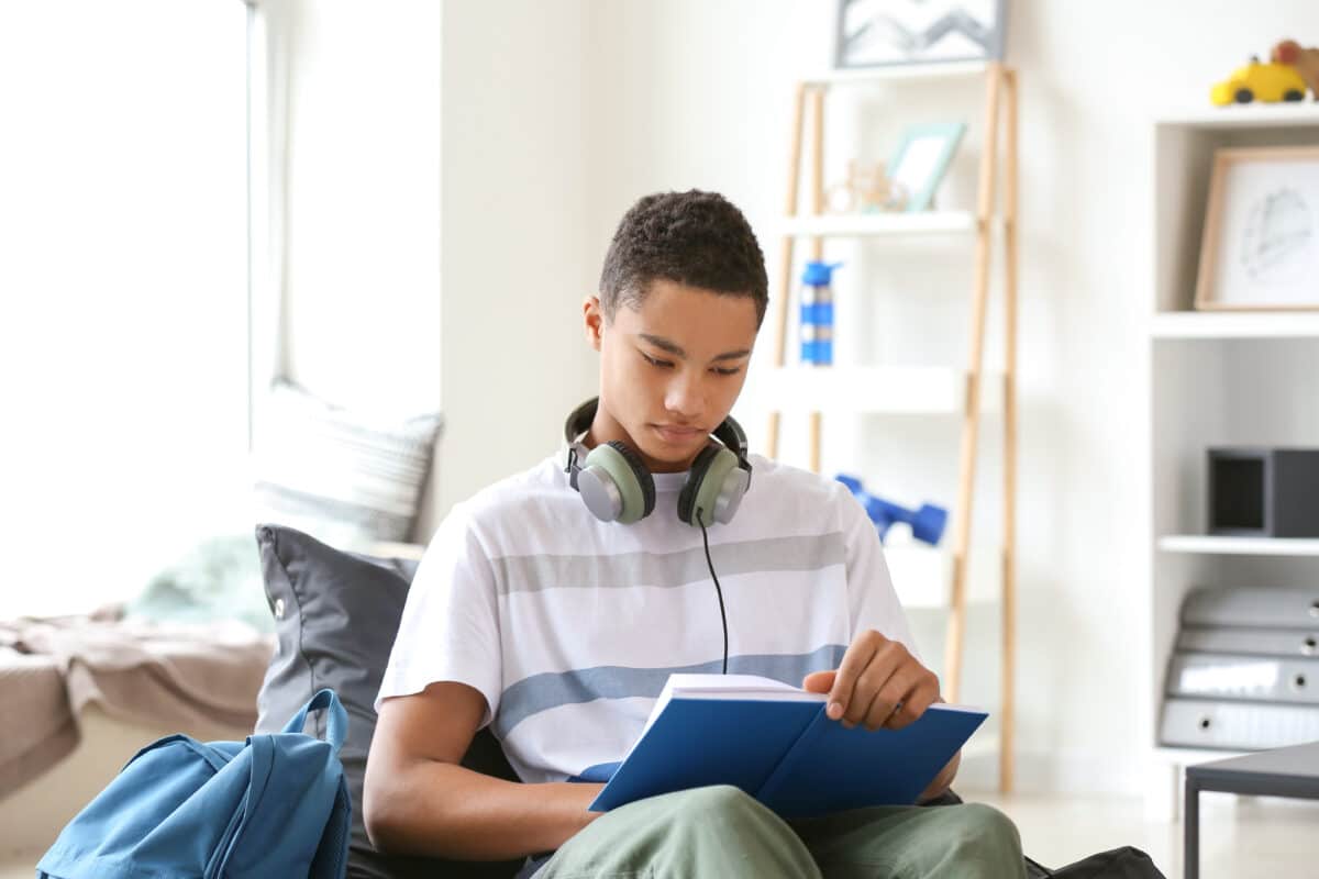 Teen boy reading book or studying for school