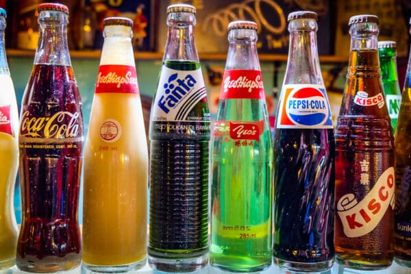 A collection of original unopened vintage soft drink bottles.