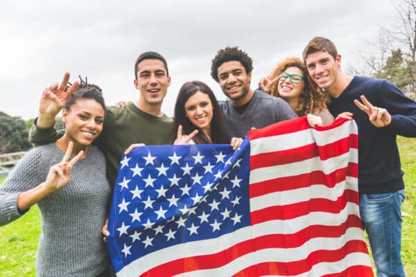 A group of young Americans showing pride and patriotism holding the USA flag