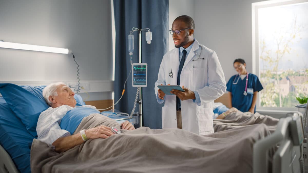 Doctor speaks to elderly patient