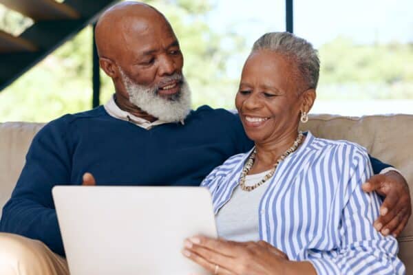 Happy senior couple looking at a computer