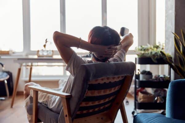 Happy person enjoying the simple life, leaning back in their office chair relaxed