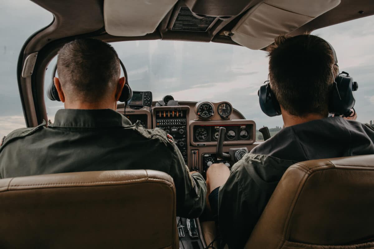 Small airplane pilots navigating through stormy weather