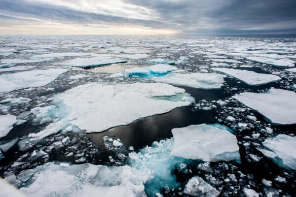 Dramatic wide angle view of melting arctic sea ice floes breaking up