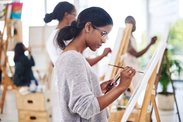 Woman painting in an art class