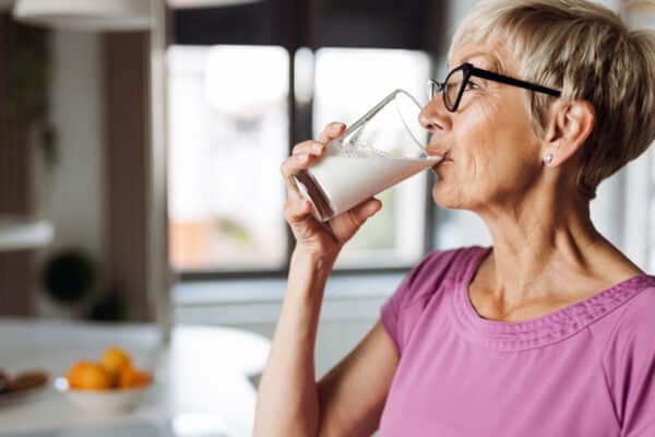 Older woman drinking a glass of milk