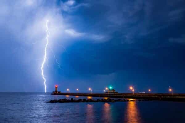 Lightning strikes Lake Superior behind the Duluth North Pier Lighthouse in Canal Park, Minnesota