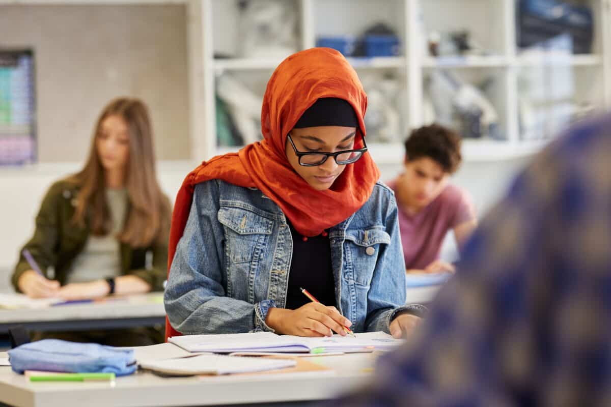 Muslim or Arab student doing work, taking exam in school